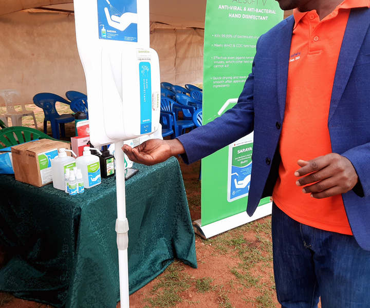 An invitee using SARAYA's dispenser at the World Patient Safety Day 2023 event in Uganda.